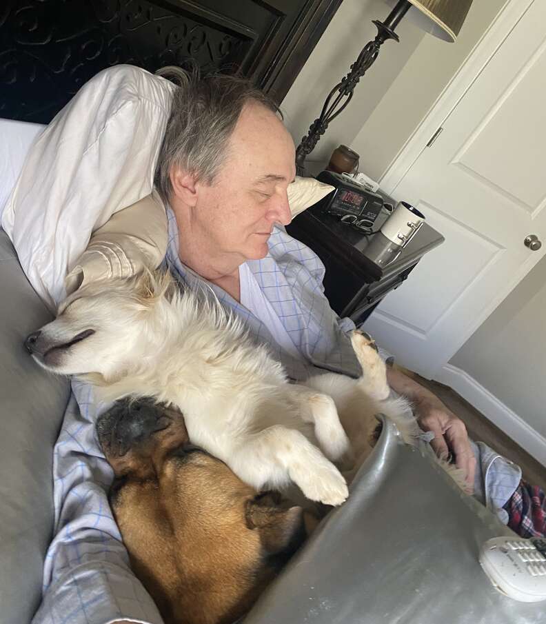 Dad snuggles with the neighborhood dogs